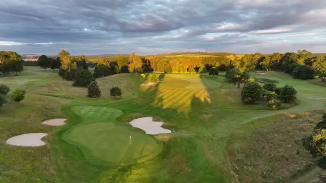 Beautiful aerial view of a golf course with sand traps and lush greenery.